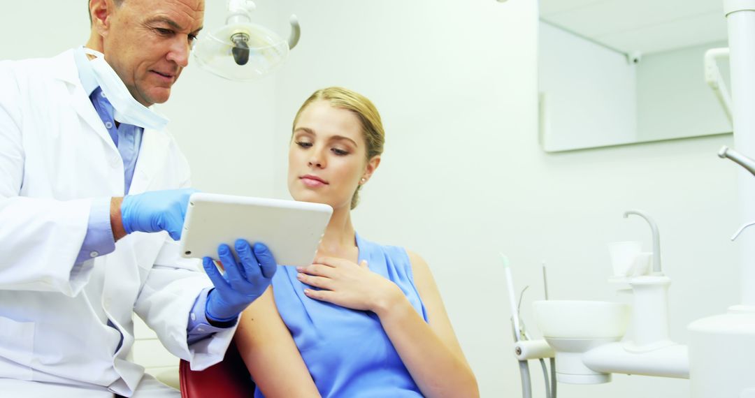 Dentist Showing Digital X-ray to Patient During Consultation in Modern Clinic - Free Images, Stock Photos and Pictures on Pikwizard.com