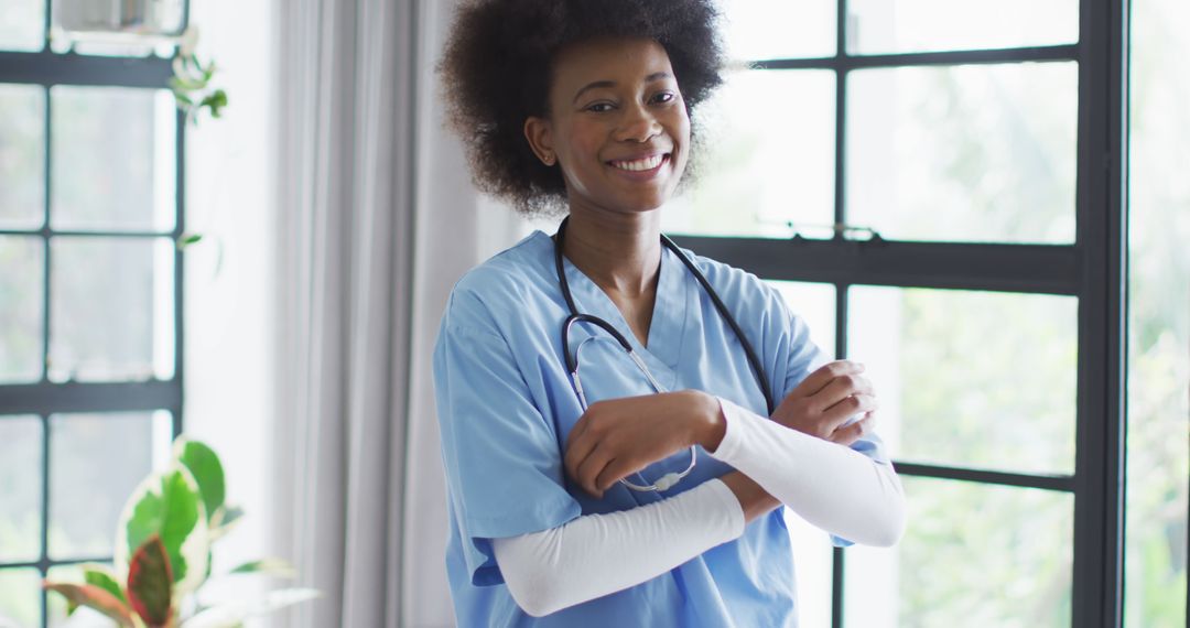 Confident Young African American Nurse in Blue Scrub Smiling - Free Images, Stock Photos and Pictures on Pikwizard.com