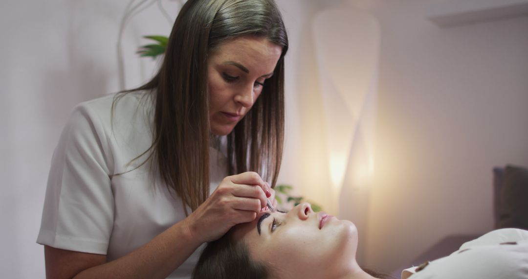 Woman Receiving Professional Eyebrow Treatment in Spa - Free Images, Stock Photos and Pictures on Pikwizard.com