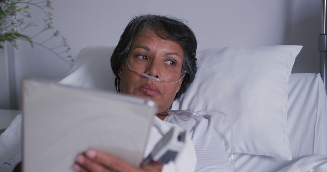 Elderly Patient Reading Tablet on Hospital Bed - Free Images, Stock Photos and Pictures on Pikwizard.com