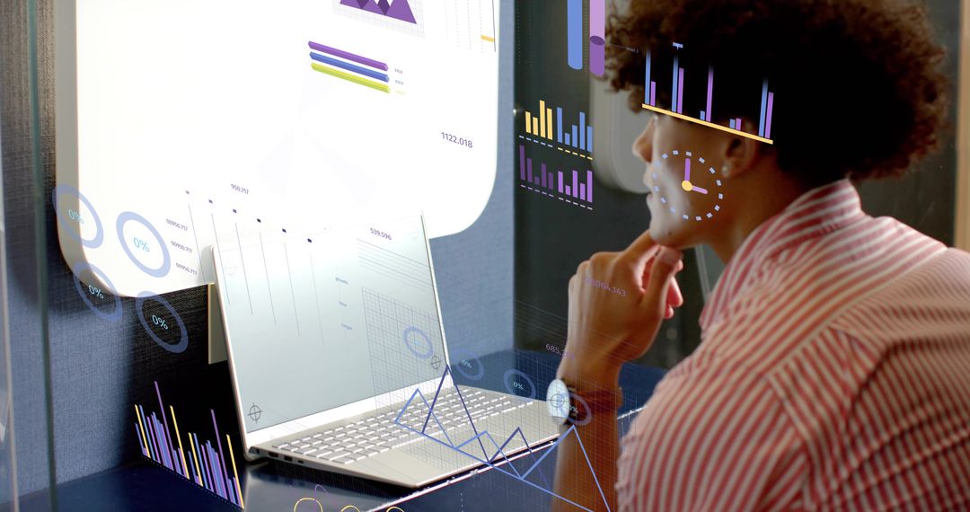Focused Analyst Analyzing Augmented Reality Data Dashboards on Laptop in Modern Workspace