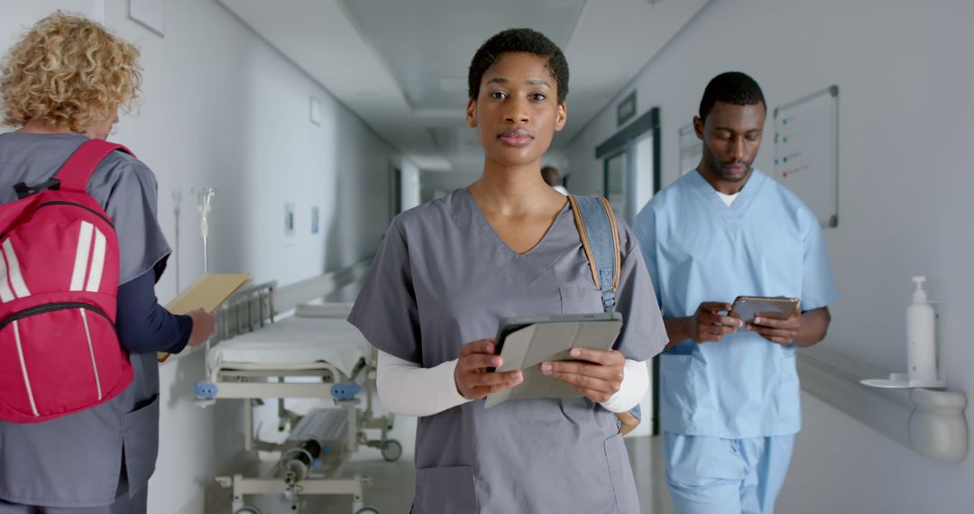 Medical Professionals Walking Through Hospital Corridor - Free Images, Stock Photos and Pictures on Pikwizard.com