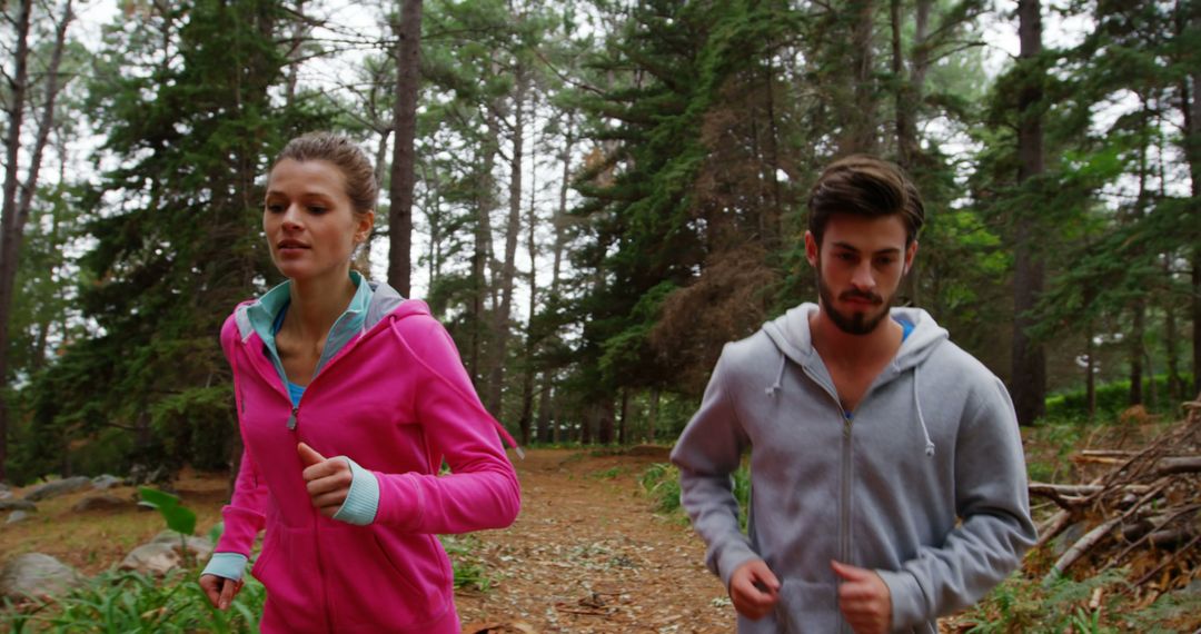 Young Couple Jogging through Forest Trail in Autumn - Free Images, Stock Photos and Pictures on Pikwizard.com