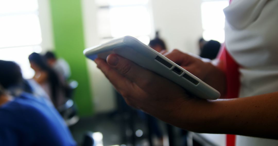 Person Holding Tablet in Modern Classroom - Free Images, Stock Photos and Pictures on Pikwizard.com