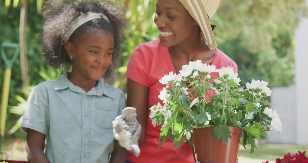 African American Mother and Daughter Gardening Together Outdoors - Free Images, Stock Photos and Pictures on Pikwizard.com