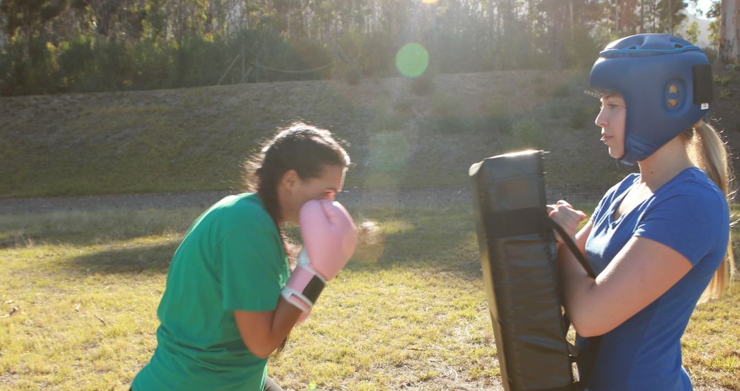 Female Martial Artists Practicing with Headgear and Kick Pad Outdoors - Free Images, Stock Photos and Pictures on Pikwizard.com