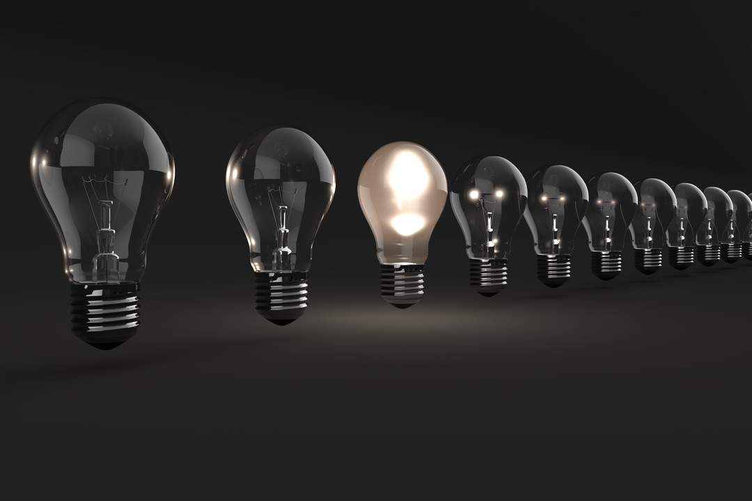 Row of Transparent Light Bulbs with One Lit Against Black Background - Download Free Stock Images Pikwizard.com