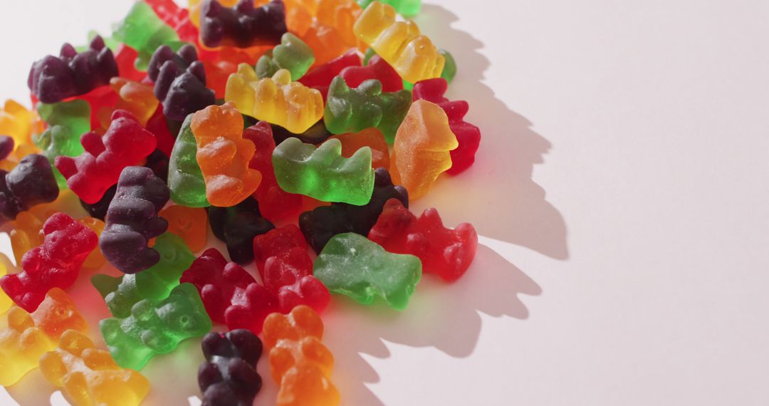 Colorful Fruit-Flavored Gummy Bears Piling on White Background - Free Images, Stock Photos and Pictures on Pikwizard.com