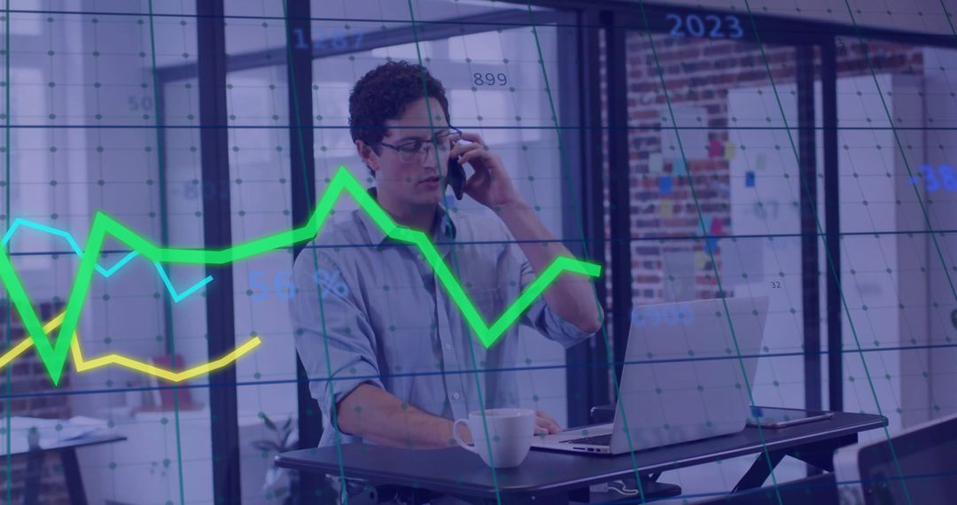 Businessman Strategizing with Financial Graphs in Modern Office