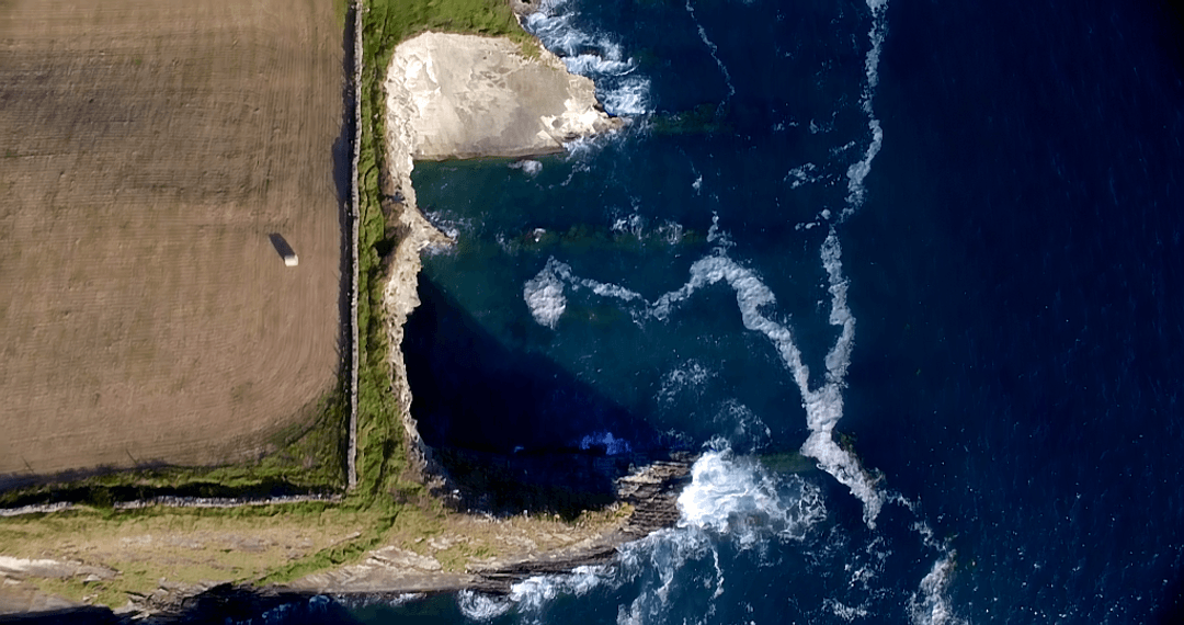 Aerial Transparent View of Coastal Rock Formations on Sunny Day