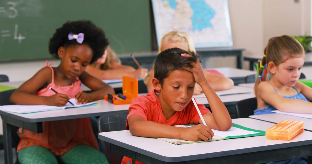 Young Students Focused on Classroom Homework at Desk - Free Images, Stock Photos and Pictures on Pikwizard.com