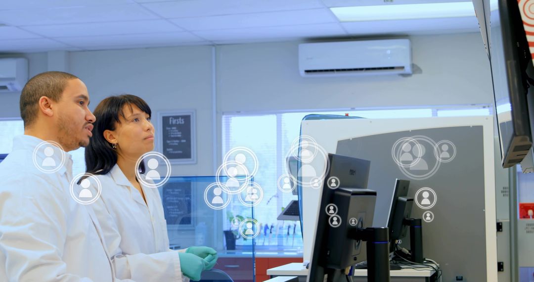 Laboratory researchers monitoring digital displays with collaborative avatar overlays