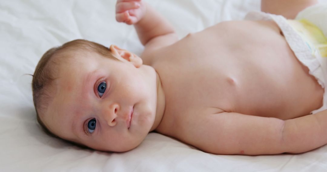 Adorable Newborn Baby Lying on Bed - Free Images, Stock Photos and Pictures on Pikwizard.com