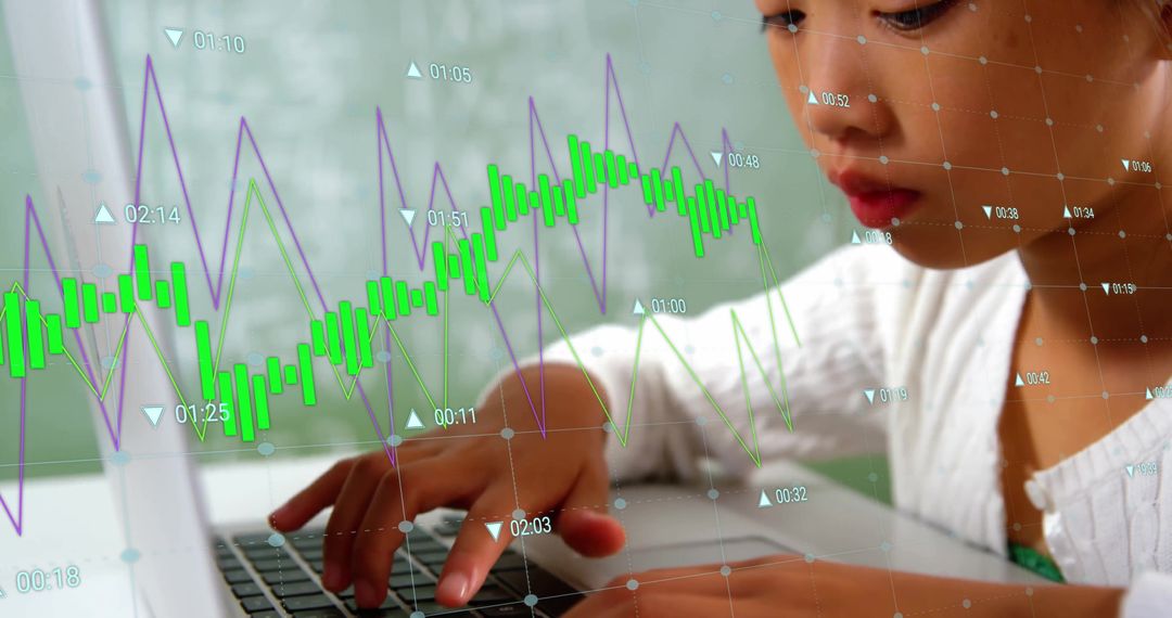 Young Asian Girl Using Laptop with Data Overlays in Educational Setting