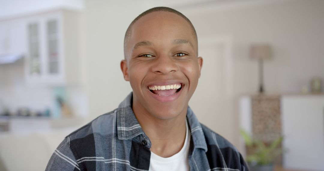 Young African American Man Smiling Brightly at Home - Free Images, Stock Photos and Pictures on Pikwizard.com