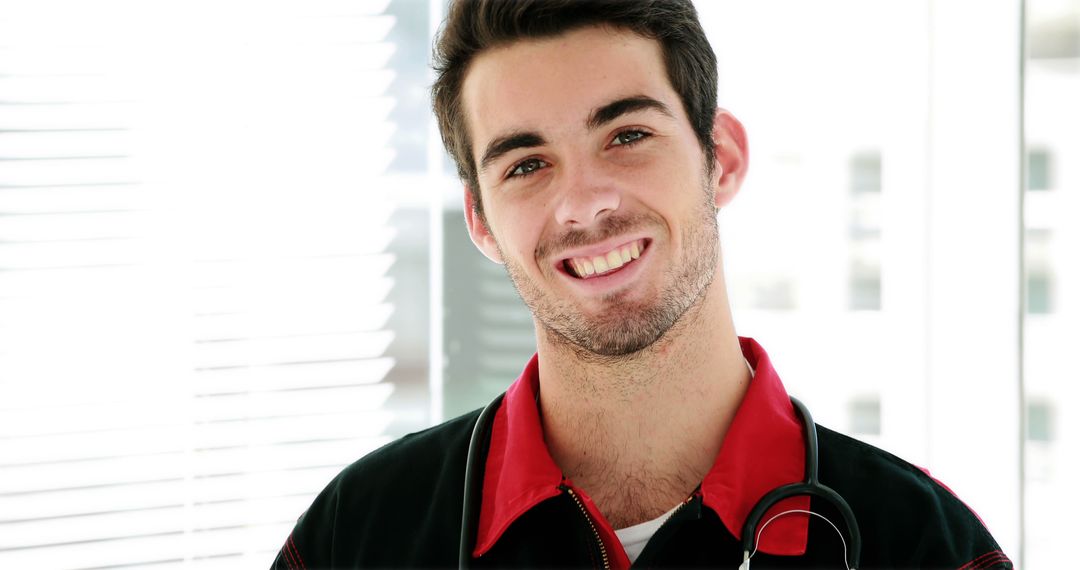 Smiling Young Medical Professional with Stethoscope in Bright Office - Free Images, Stock Photos and Pictures on Pikwizard.com