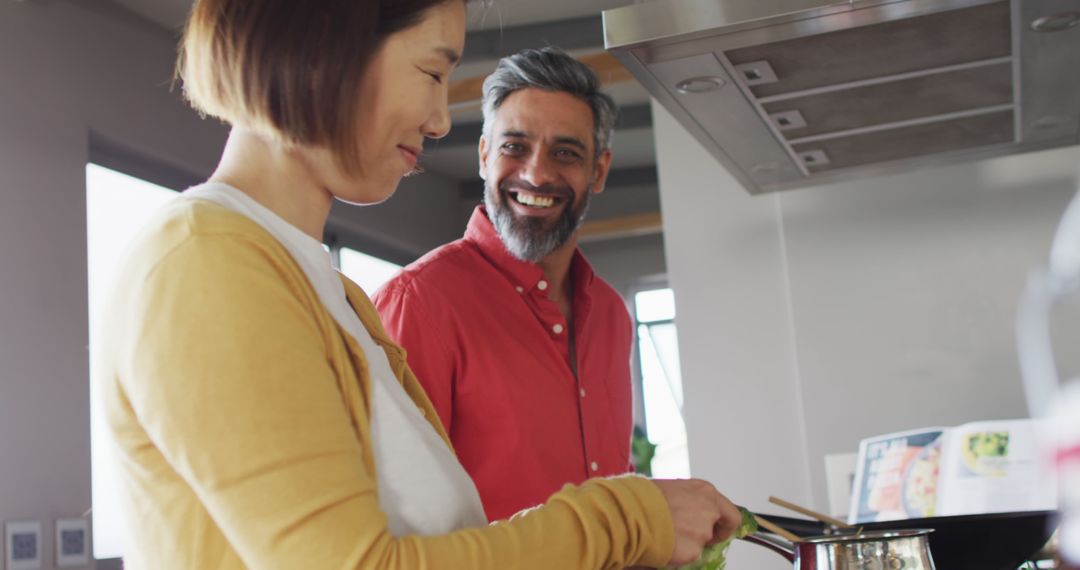 Couple Cooking Together in Modern Kitchen, Smiling - Free Images, Stock Photos and Pictures on Pikwizard.com