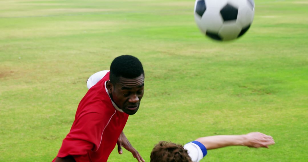 Soccer players competing for ball during match on grassy field - Free Images, Stock Photos and Pictures on Pikwizard.com