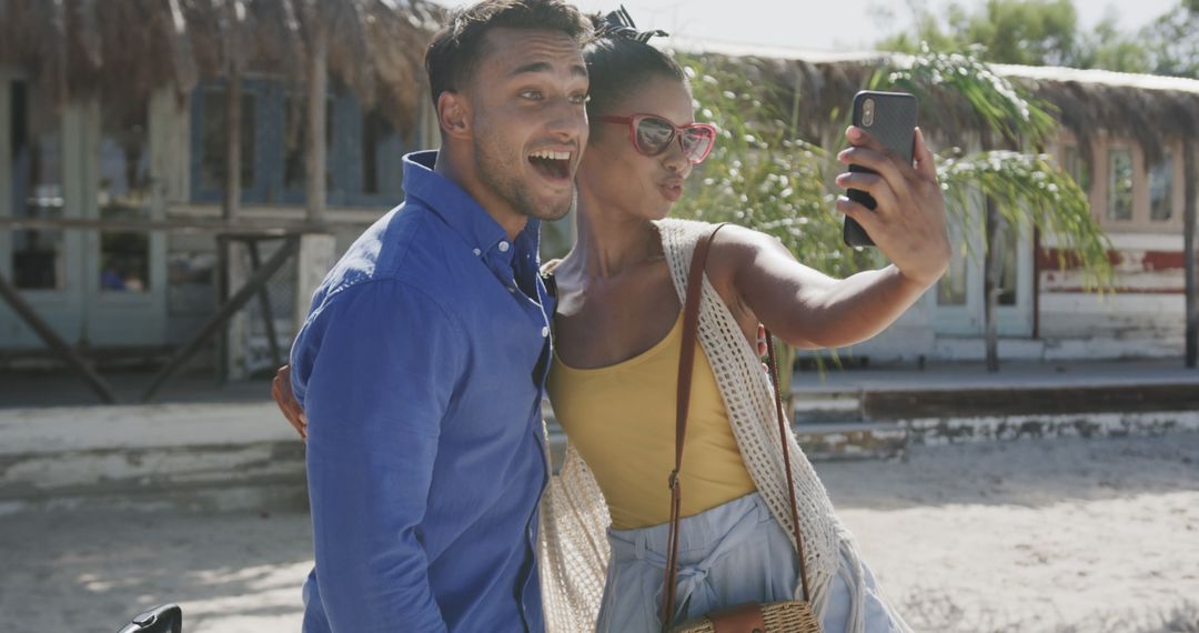 Happy Couple on Tropical Vacation Taking Selfie by Beach Hut - Free Images, Stock Photos and Pictures on Pikwizard.com