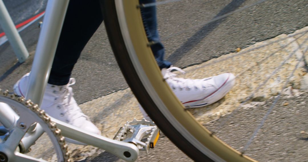 Person Walking Bicycle Across Street in White Sneakers - Free Images, Stock Photos and Pictures on Pikwizard.com