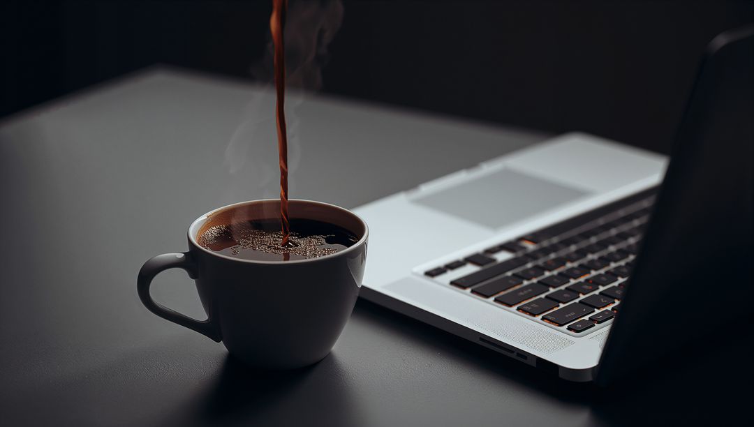 Pouring Fresh Coffee into White Mug Next to Laptop on Minimal Dark Workspace for Productivity