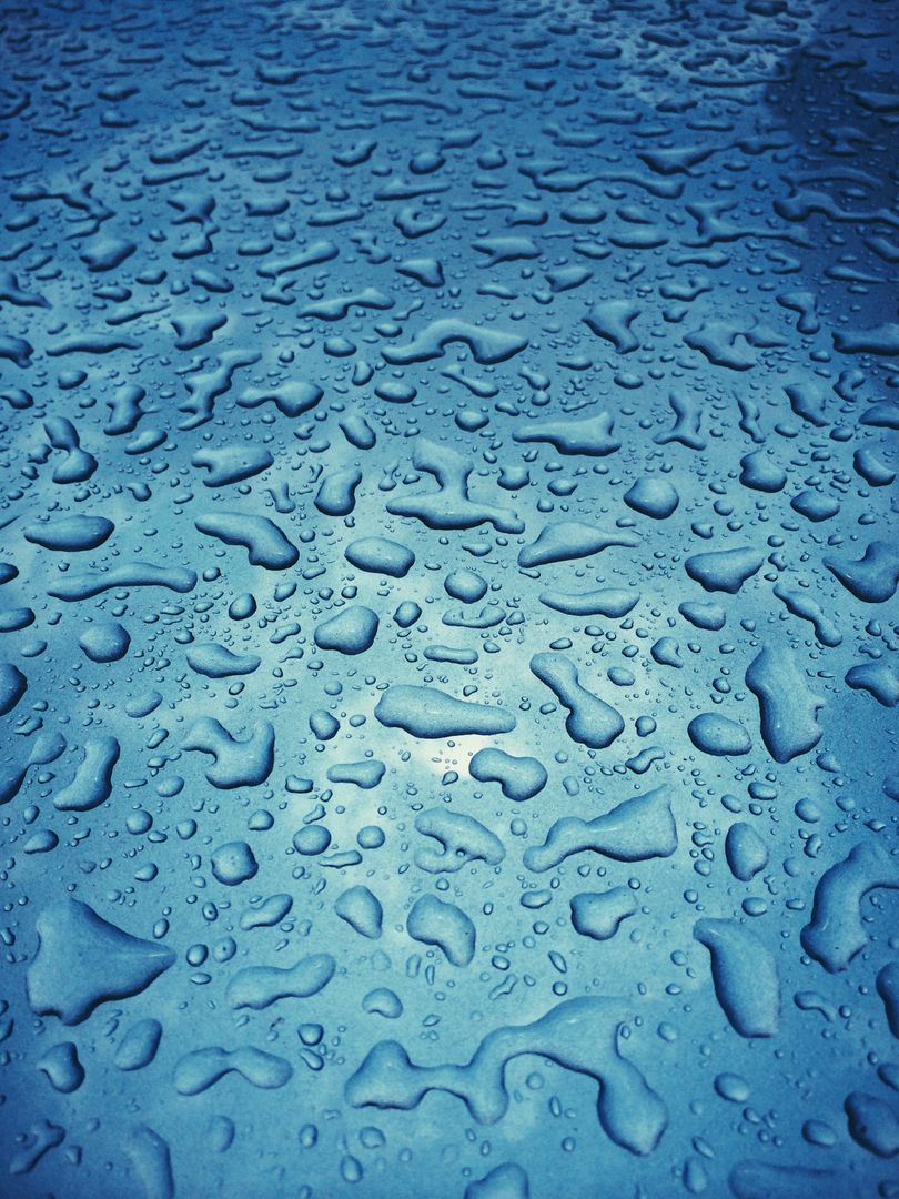 Close-Up of Water Droplets on Blue Surface Capturing Texture and Reflection - Free Images, Stock Photos and Pictures on Pikwizard.com