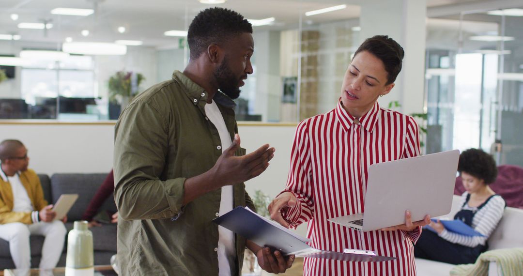 Diverse Colleagues Engaged in Productive Office Discussion