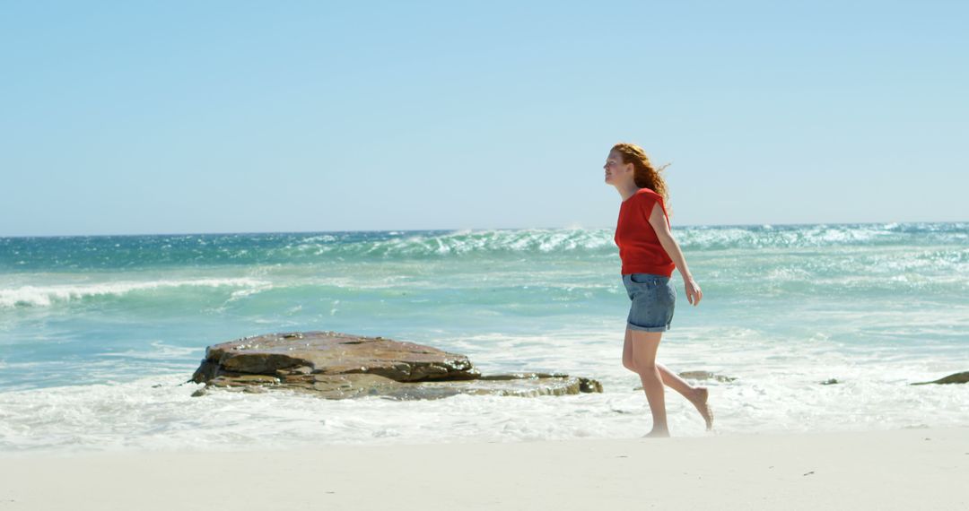 Woman Enjoying a Walk on a Sunny Beach - Free Images, Stock Photos and Pictures on Pikwizard.com