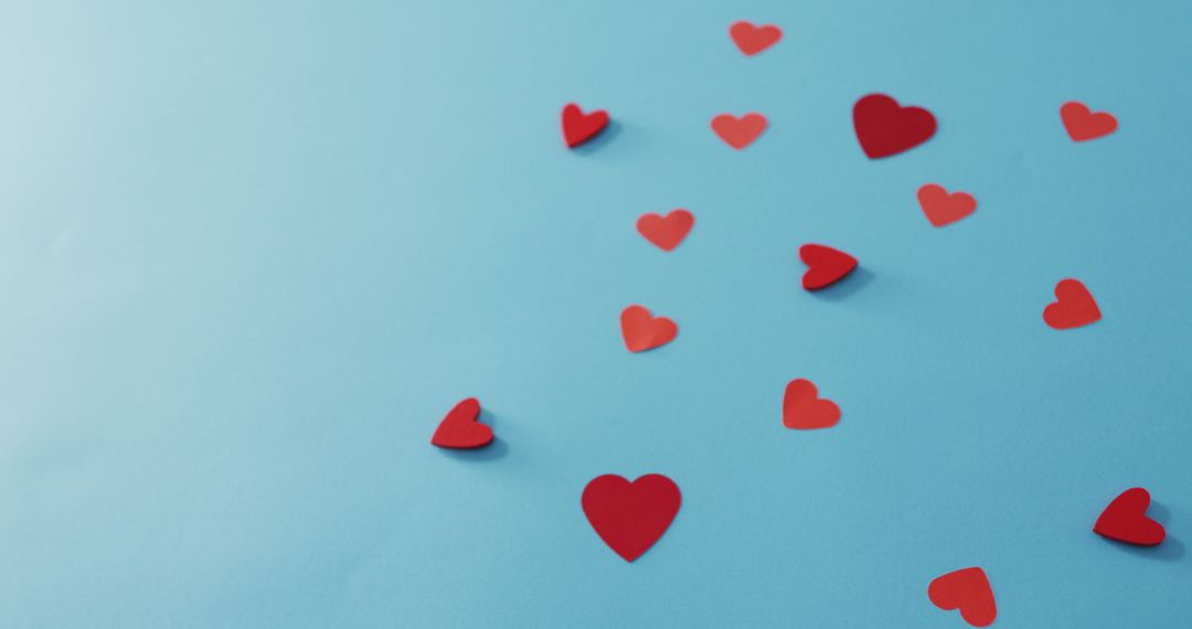 Red Paper Hearts on Blue Background for Valentine's Day Concept