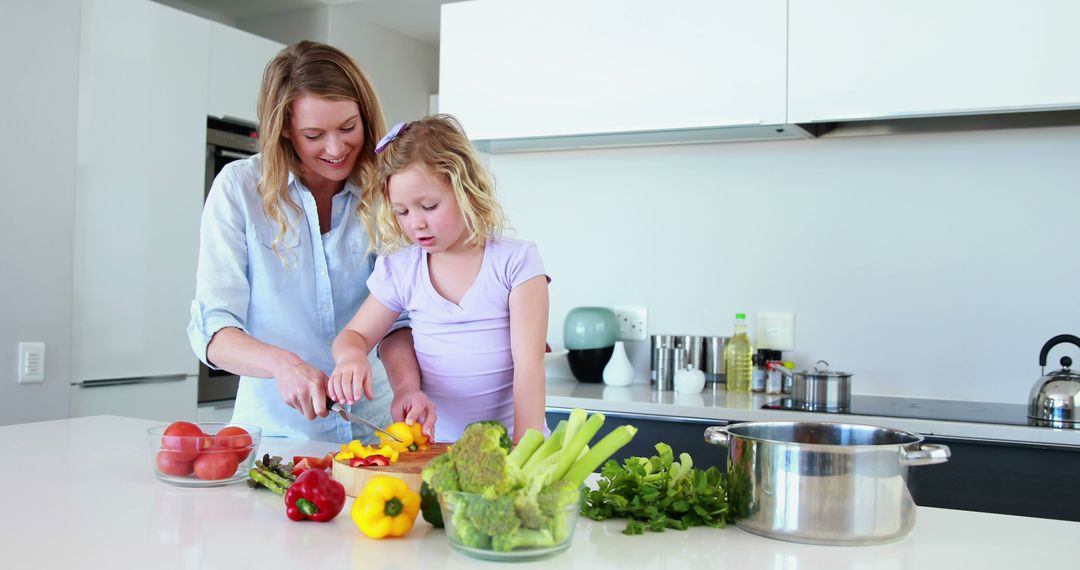 Mother and Daughter Preparing Vegetables Together in Modern Kitchen - Free Images, Stock Photos and Pictures on Pikwizard.com