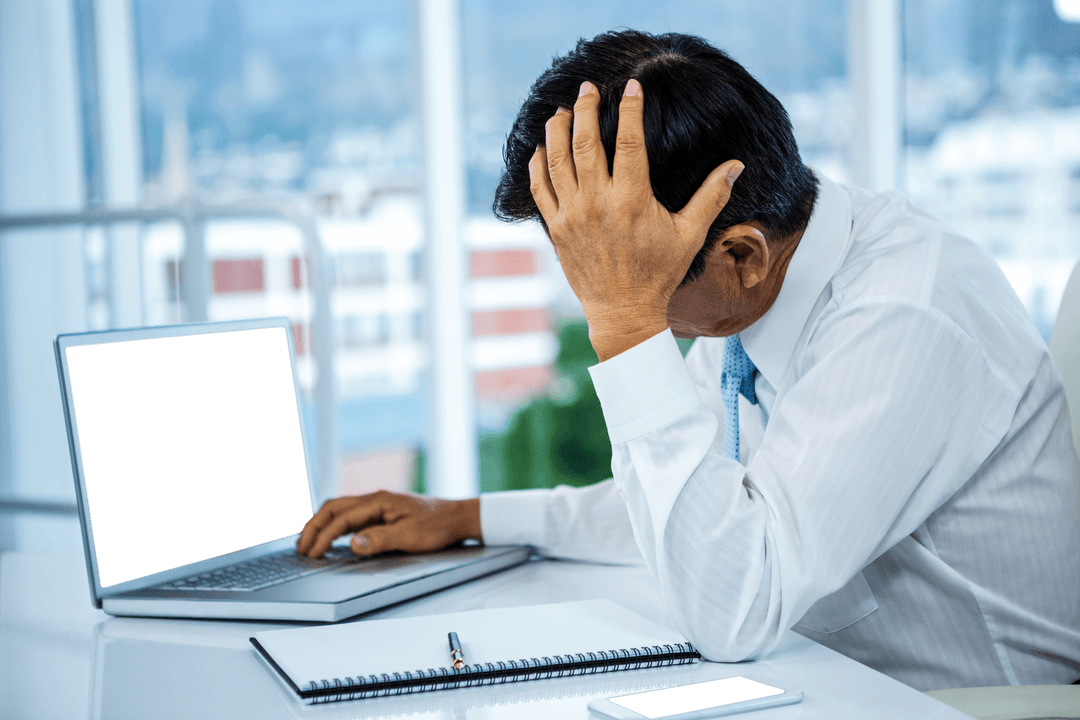 Frustrated Businessman at Desk with Transparent Laptop Screen