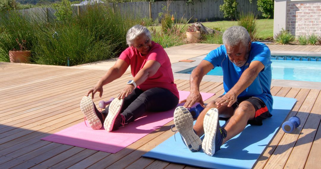 Senior Couple Enjoying Stretching Exercises at Home Poolside