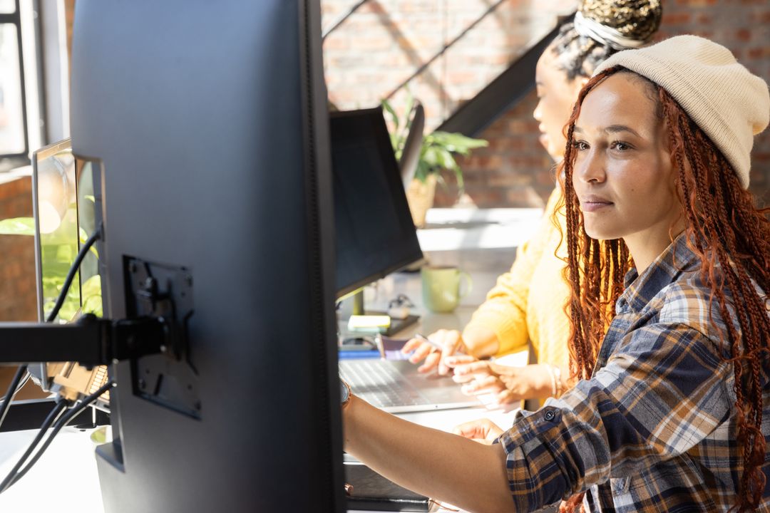 Diverse coworkers collaborating in open plan office setting