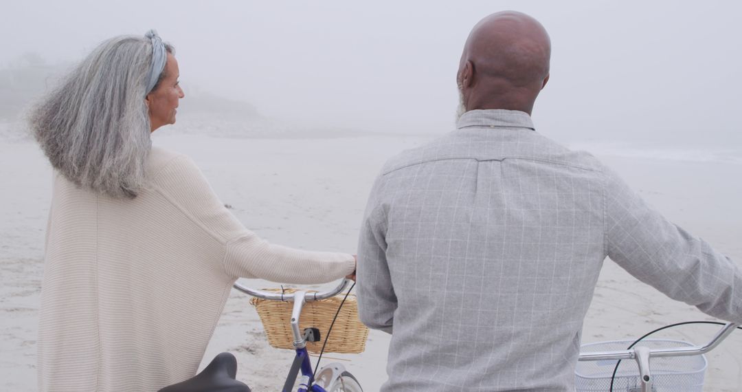 Seniors Enjoying Peaceful Bike Ride on Foggy Beach - Free Images, Stock Photos and Pictures on Pikwizard.com