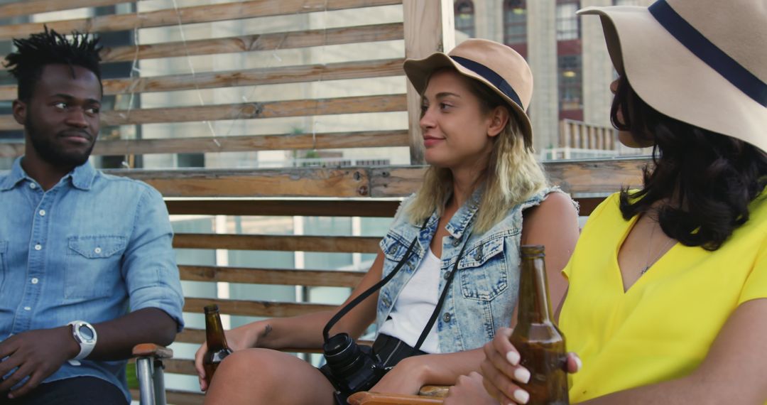 Friends Enjoying Rooftop Party with Drinks and Laughter