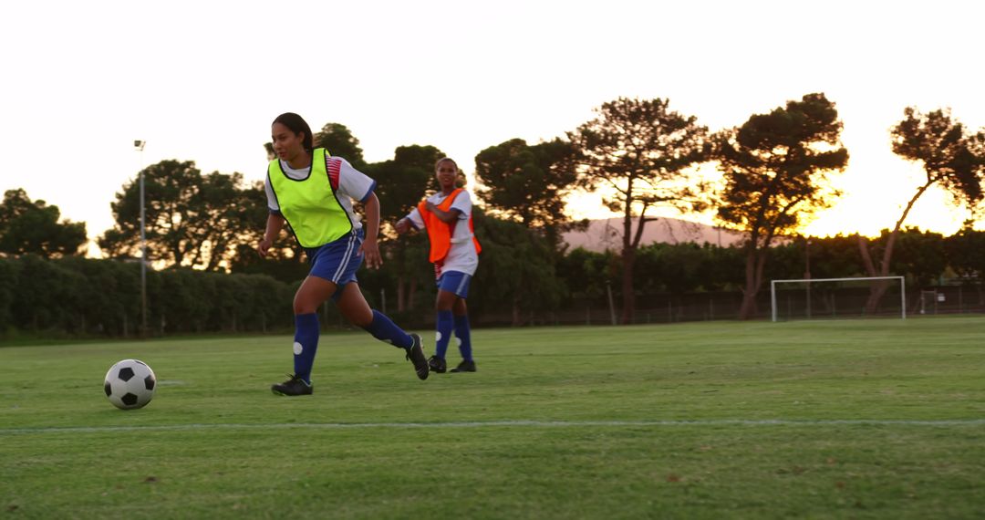 Female Soccer Players Practicing on Field at Sunset - Free Images, Stock Photos and Pictures on Pikwizard.com