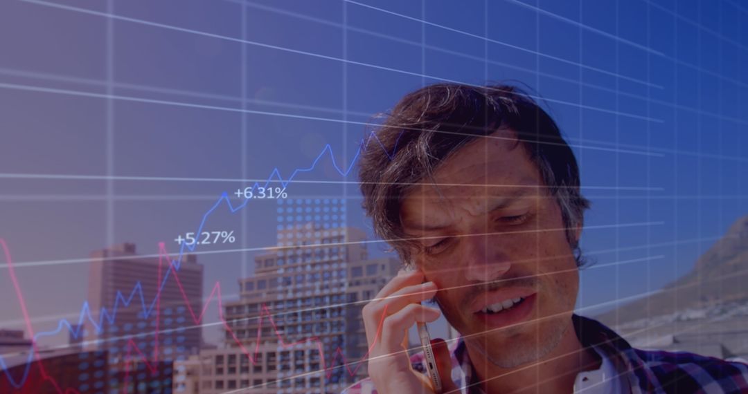 Businessman Analyzing Financial Data While on a Call