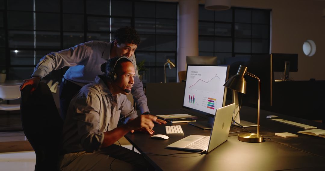 Business Team Analyzing Data on Desktop in Late Night Office
