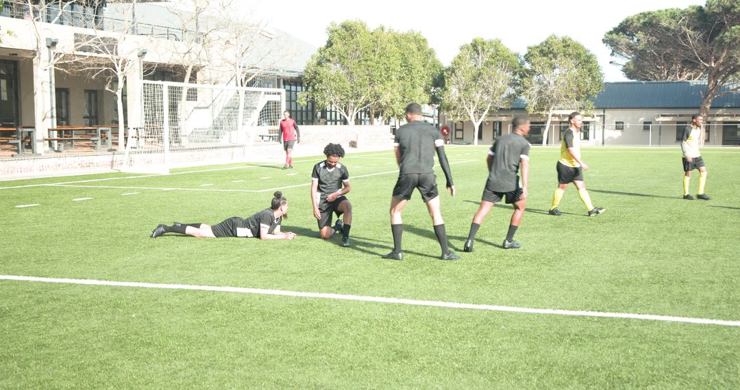 Soccer Players Engaged in Intense Match on Sunny Field