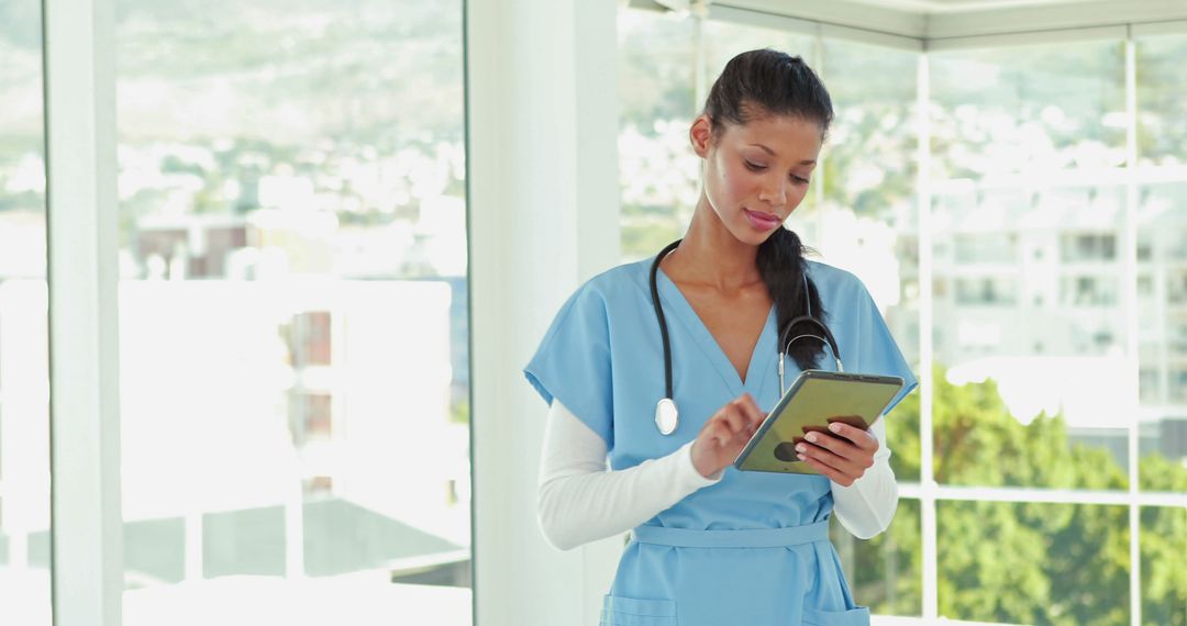 Female Doctor Using Tablet in Hospital Office - Free Images, Stock Photos and Pictures on Pikwizard.com