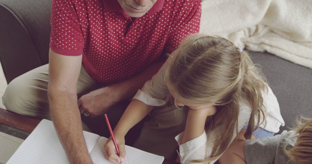 Elderly Man Helping a Young Girl with Homework at Home - Free Images, Stock Photos and Pictures on Pikwizard.com