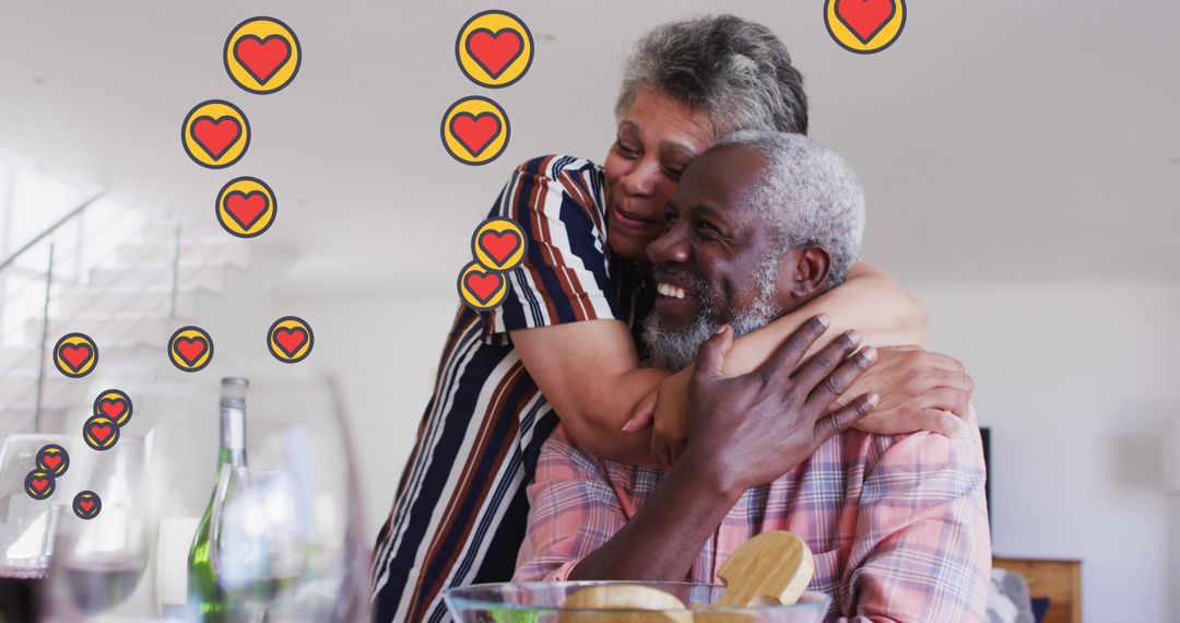 Happy Senior Couple Embracing at Home with Heart Icons