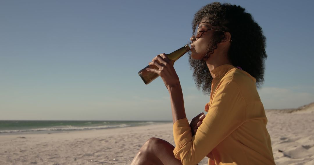 Young Woman Enjoying Cold Beverage at Beach - Free Images, Stock Photos and Pictures on Pikwizard.com