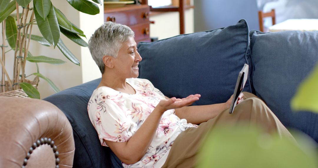 Senior Biracial Woman Using Tablet at Home Relaxing on Couch