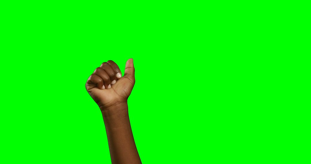 Raised fist of African American arm against green chroma key background - Free Images, Stock Photos and Pictures on Pikwizard.com