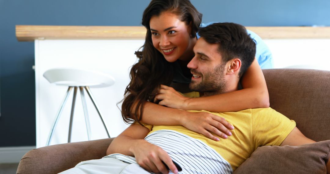 Relaxed Couple Enjoying Home Entertainment on Sofa