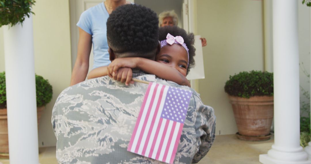 Homecoming Soldier Embraced by Family with American Flag
