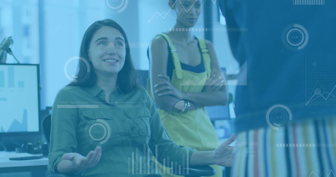 Diverse Women Collaborating on Business Data in Modern Office