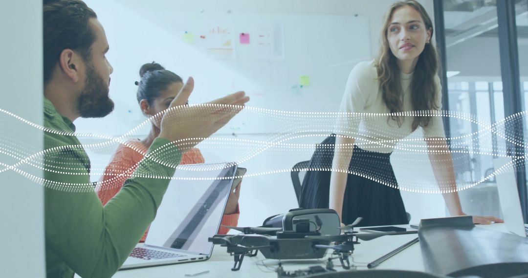 Professionals Collaborating on Drone Design in Tech Workspace