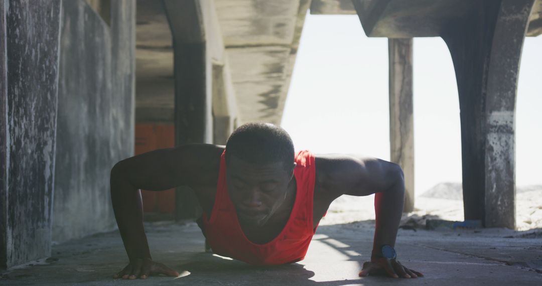 Determined Athlete Doing Push-Ups Under Beach Pier